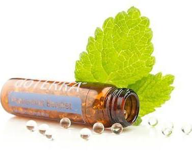 A Bottle Of Essential Oil Next To A Leaf