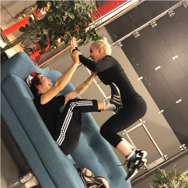 A Woman Jumping Over A Man On A Couch