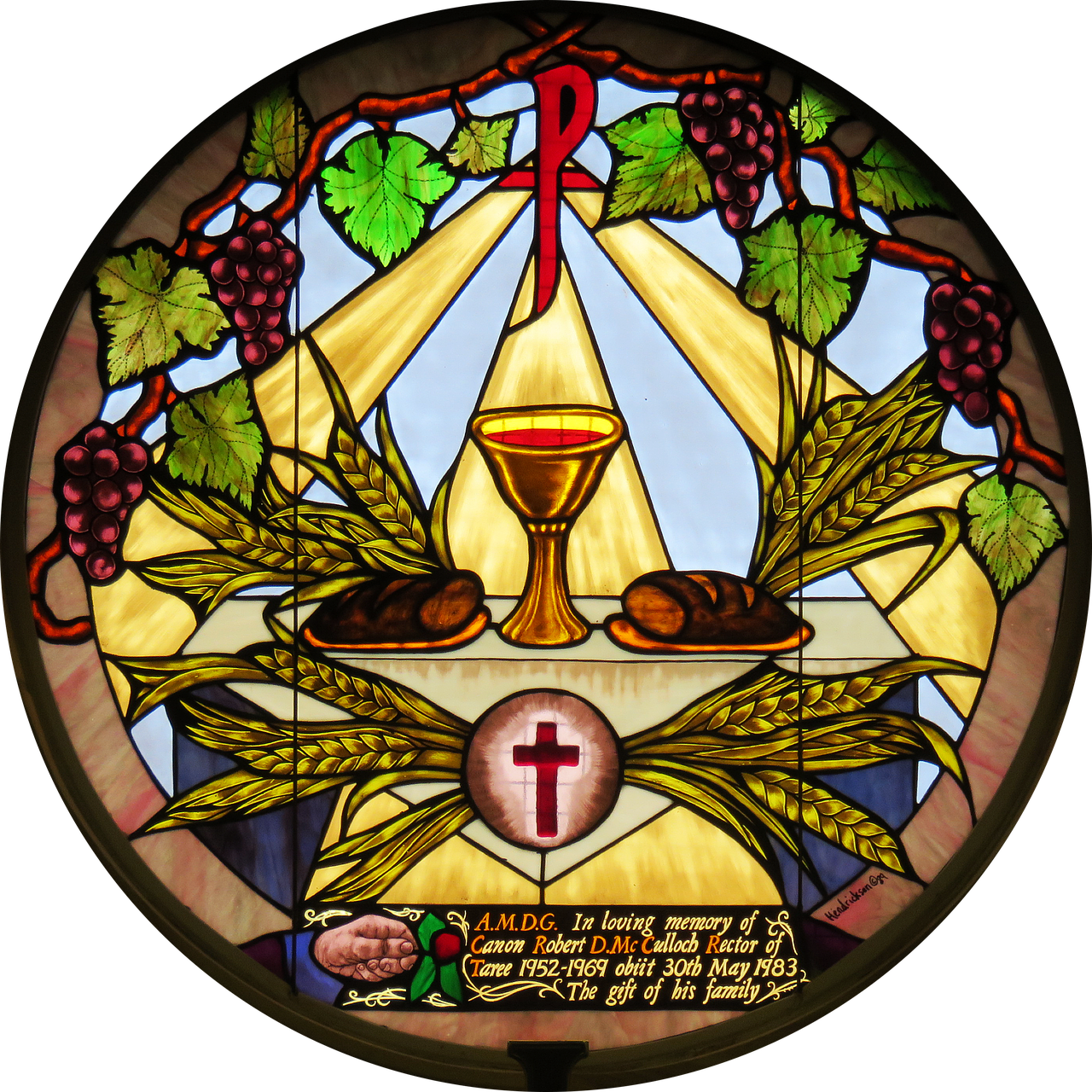 A Stained Glass Window With A Cross And Bread
