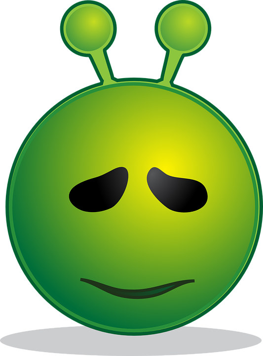 A Green Alien Face With Black Eyes And A Black Background
