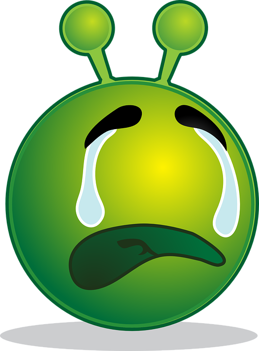 A Green Alien Face With Tears
