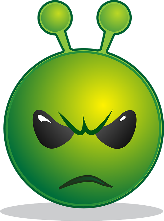 A Green Alien Face With Black Eyes And A Sad Face
