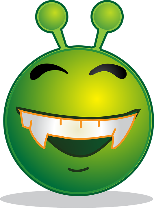 A Green Alien Face With Teeth