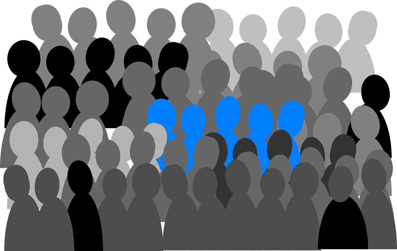 A Group Of People With One Blue One