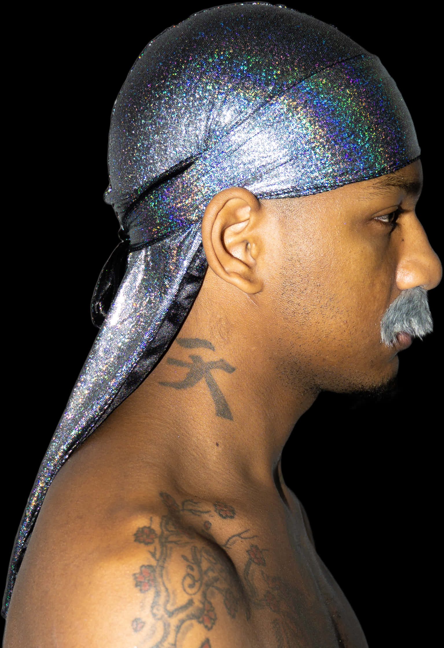 A Man With A Mustache And A Silver Head Wrap