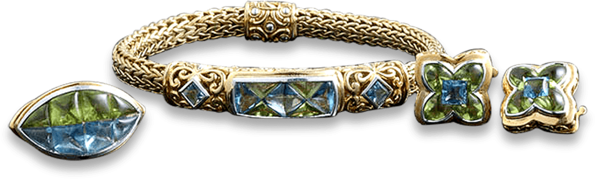 A Gold Bracelet With A Blue Gem
