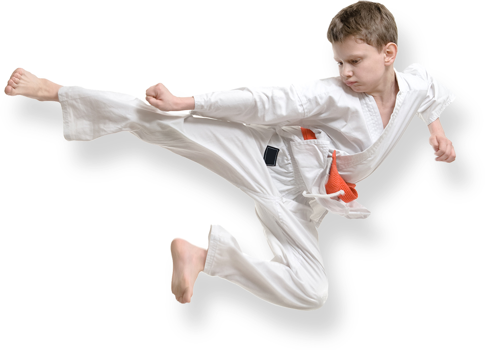 A Boy In A Karate Uniform Kicking