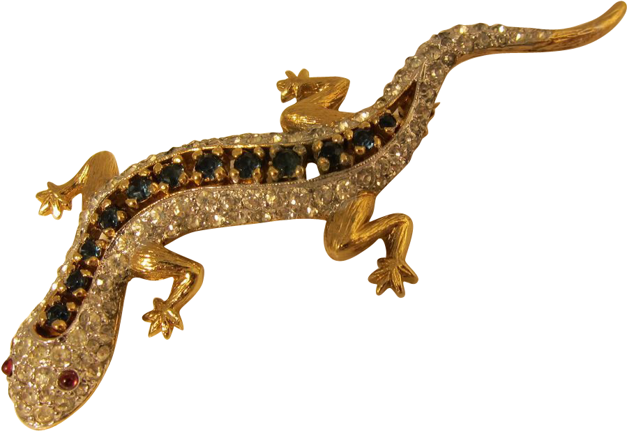 A Gold Lizard With Black And White Stones