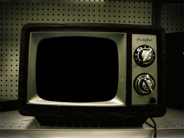 An Old Television On A Shelf
