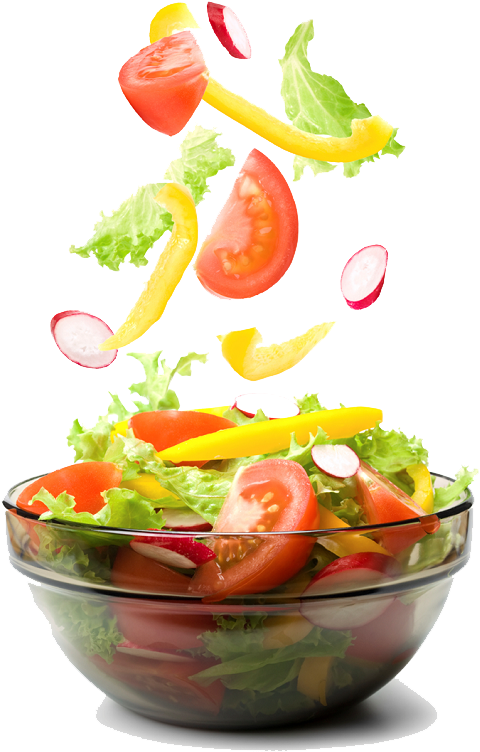 A Bowl Of Salad With Vegetables Falling