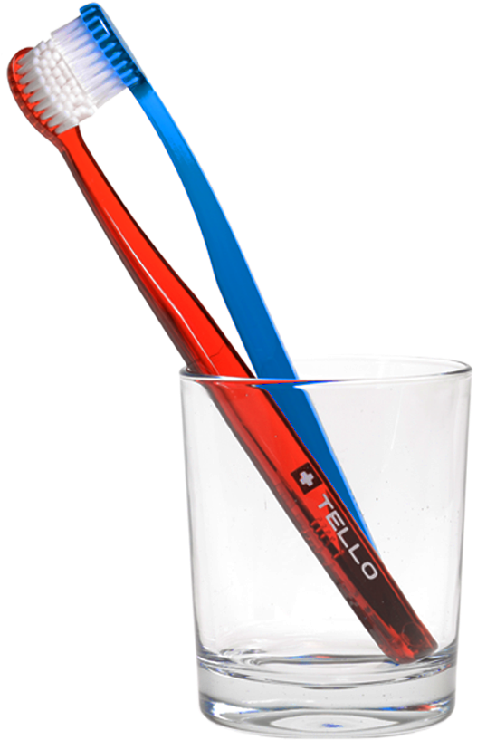 A Pair Of Toothbrushes In A Glass