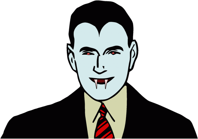 A Man In A Suit And Tie With Vampire Teeth