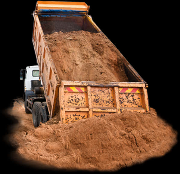 A Dump Truck Loading Dirt Into The Ground