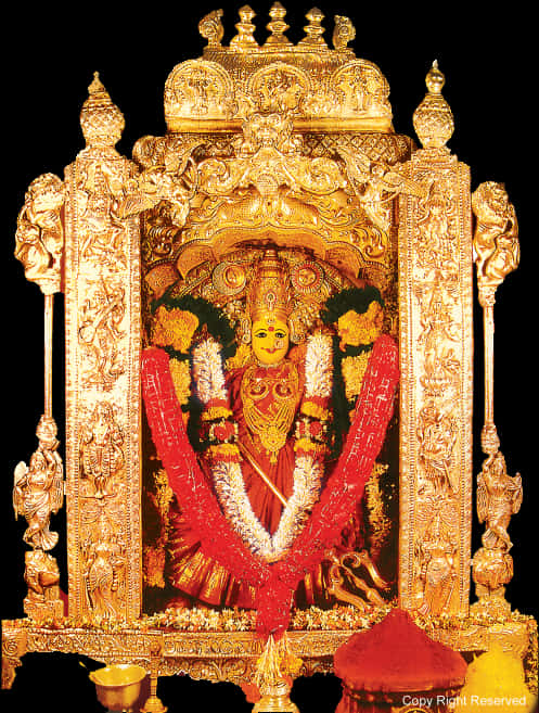 A Statue Of A Woman In A Gold Frame With Venkateswara Temple, Tirumala In The Background