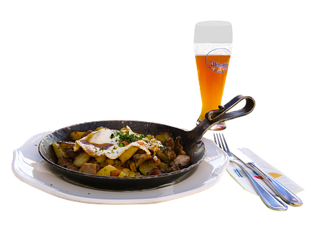A Pan Of Food And A Glass Of Beer