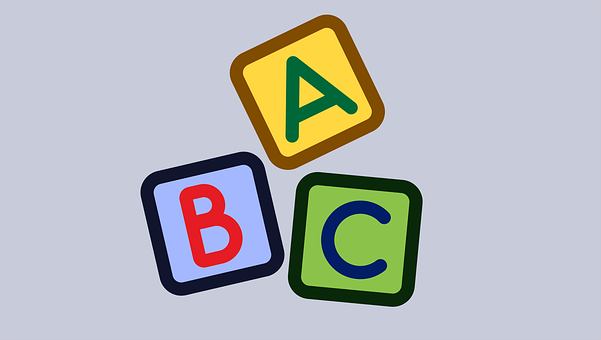 A Group Of Colorful Blocks With Letters