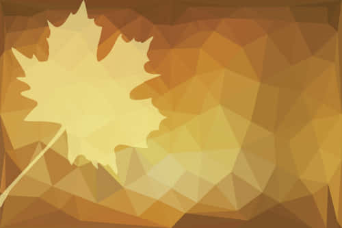 A Yellow Maple Leaf On A Brown Background