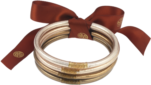 A Stack Of Gold And Silver Bracelets Tied With A Red Ribbon