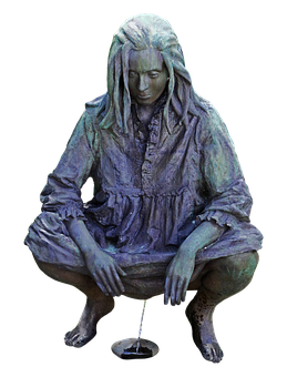 A Statue Of A Woman Sitting On The Ground