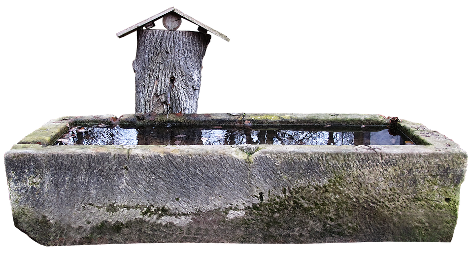 A Water Trough With A Wooden Roof