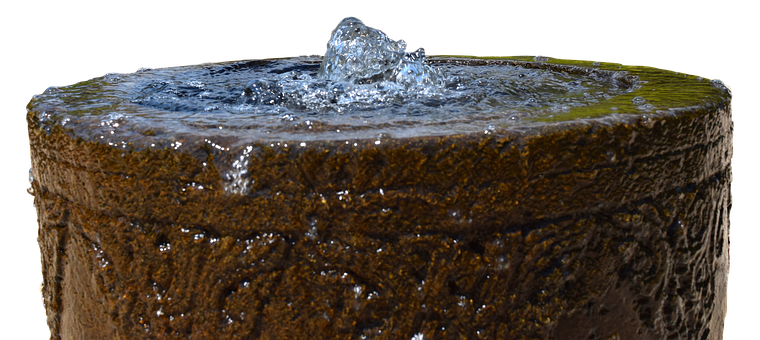 A Water Splashing Into A Stone Container