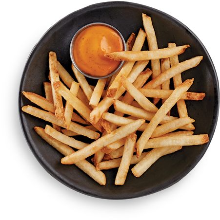 A Plate Of French Fries With Sauce