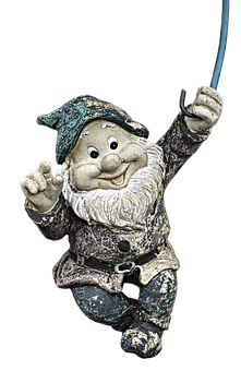A Statue Of A Gnome Holding A Wand