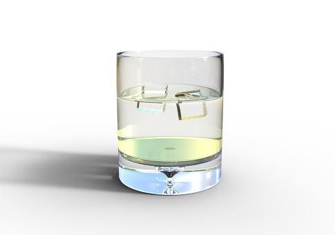 A Glass Of Liquid With Ice Cubes