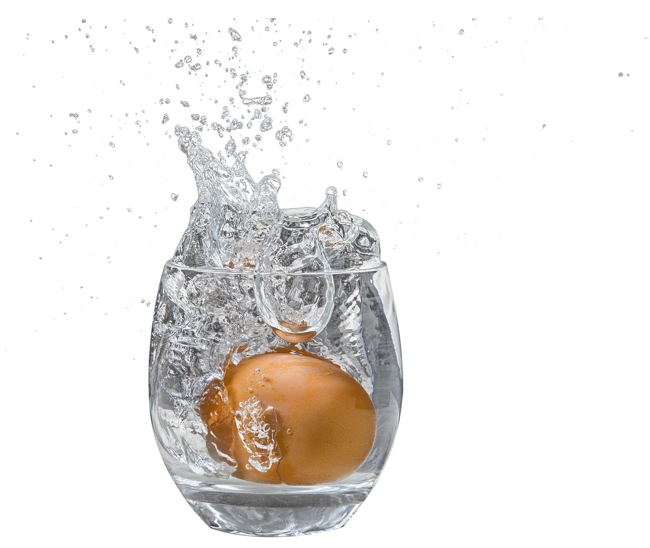 An Egg Splashing Into A Glass Of Water