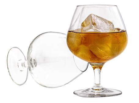 A Glass Of Alcohol With Ice And A Black Background