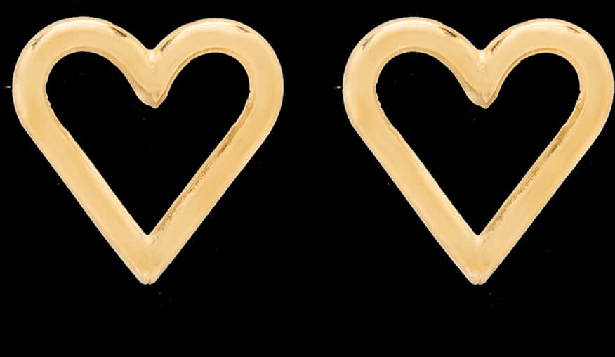A Pair Of Gold Heart Shaped Earrings