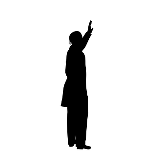 A Silhouette Of A Man Raising His Hand