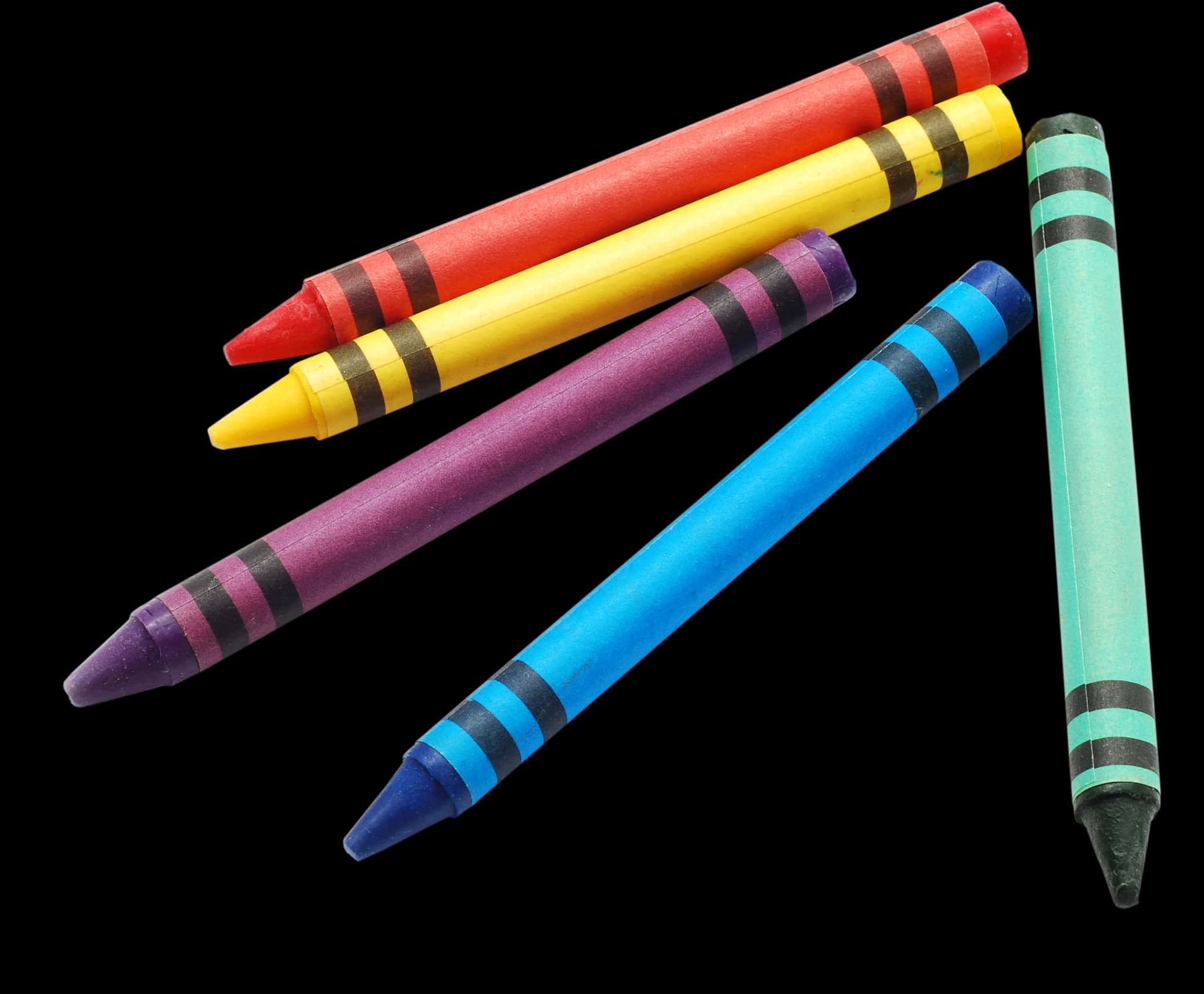 A Group Of Crayons On A Black Background