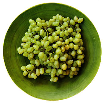A Bowl Of Grapes On A Black Background
