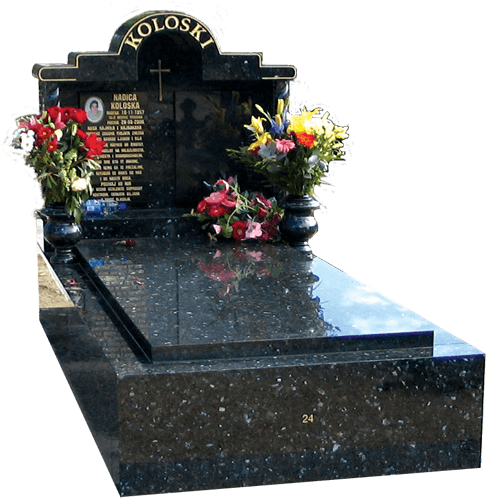 A Black Marble Tombstone With Flowers On It