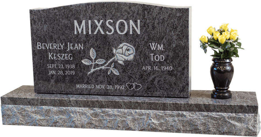 A Headstone With A Rose On It