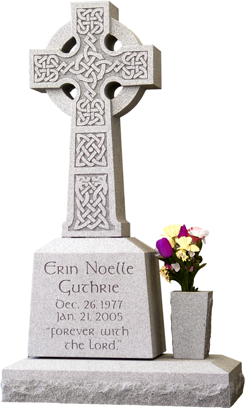 A Tombstone With A Cross And Flowers