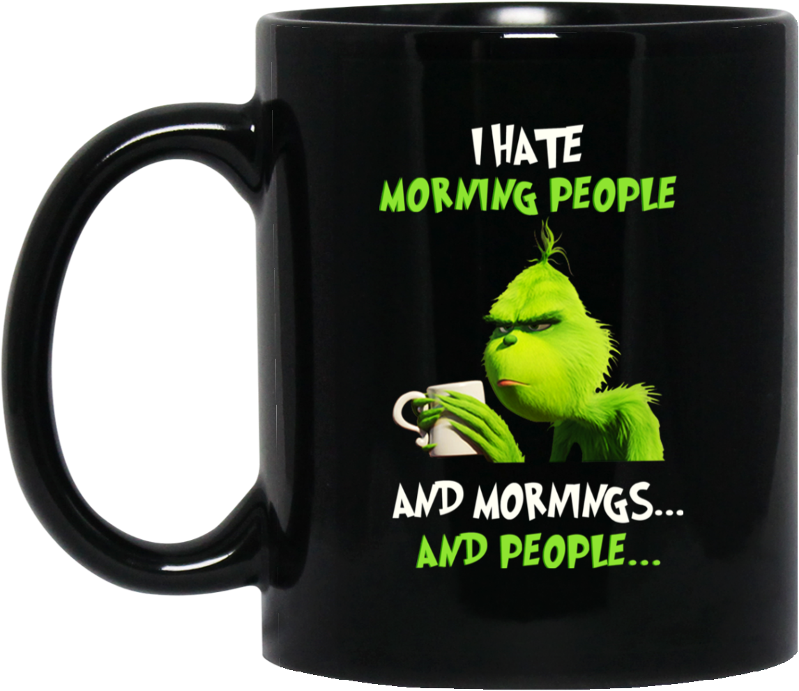 A Black Mug With A Green Cartoon Character Holding A White Mug