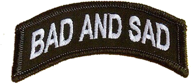 A Patch With White Text On It