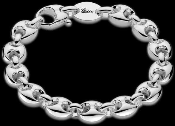 A Silver Bracelet With A Logo
