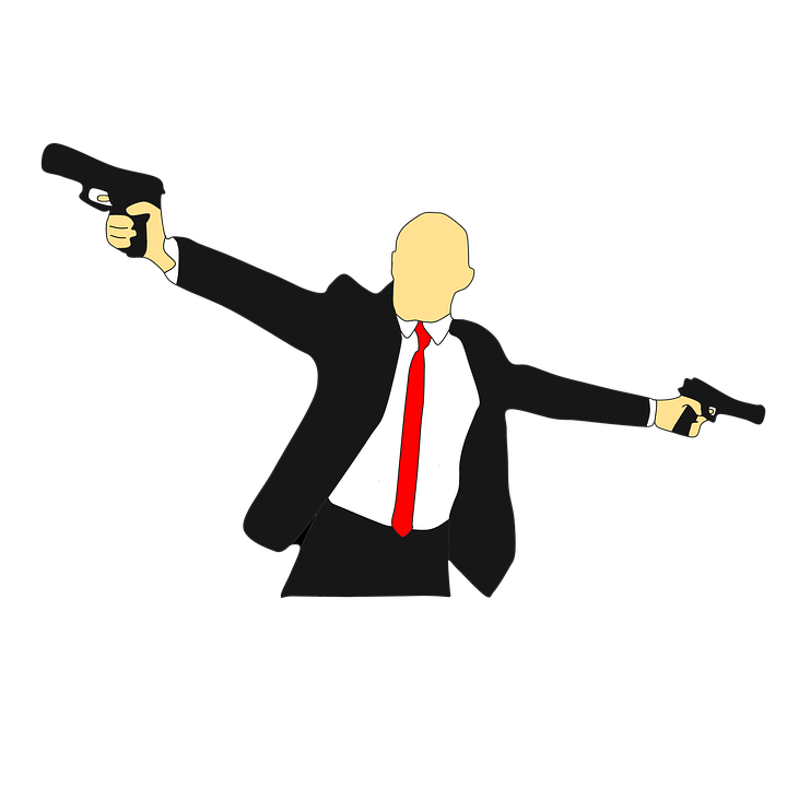 A Man In A Suit Holding Guns
