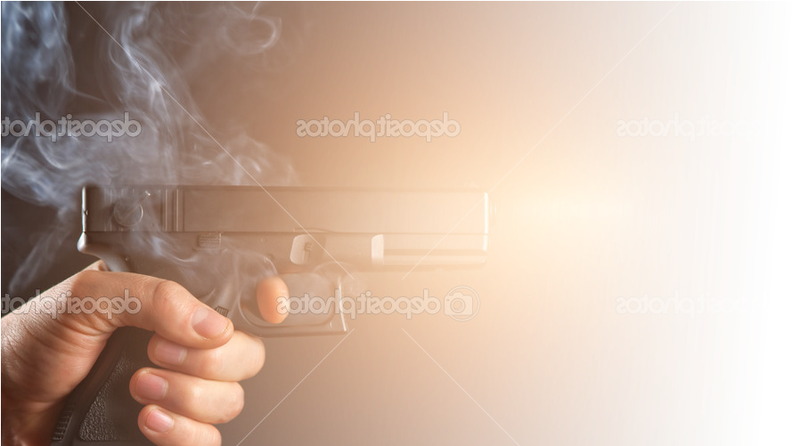 A Hand Holding A Gun With Smoke Coming Out Of It