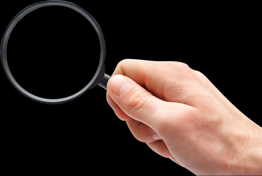 A Hand Holding A Magnifying Glass
