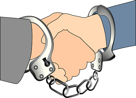 A Pair Of Hands In Handcuffs