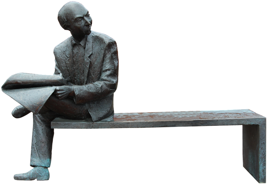 A Statue Of A Man Sitting On A Bench