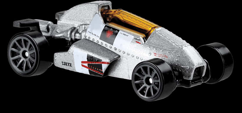A Silver Toy Car With A Bottle Of Liquid