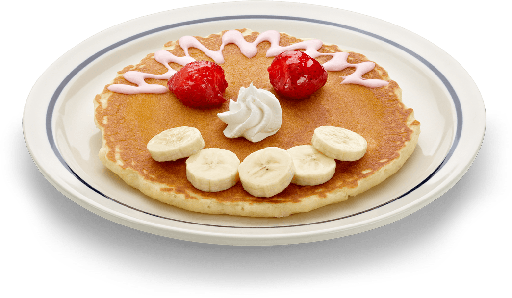 A Pancake With Fruit And Whipped Cream On A Plate