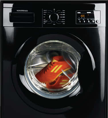 A Black Washing Machine With A Red Shoe Inside