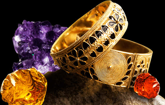 A Close Up Of A Pair Of Gold Bracelets