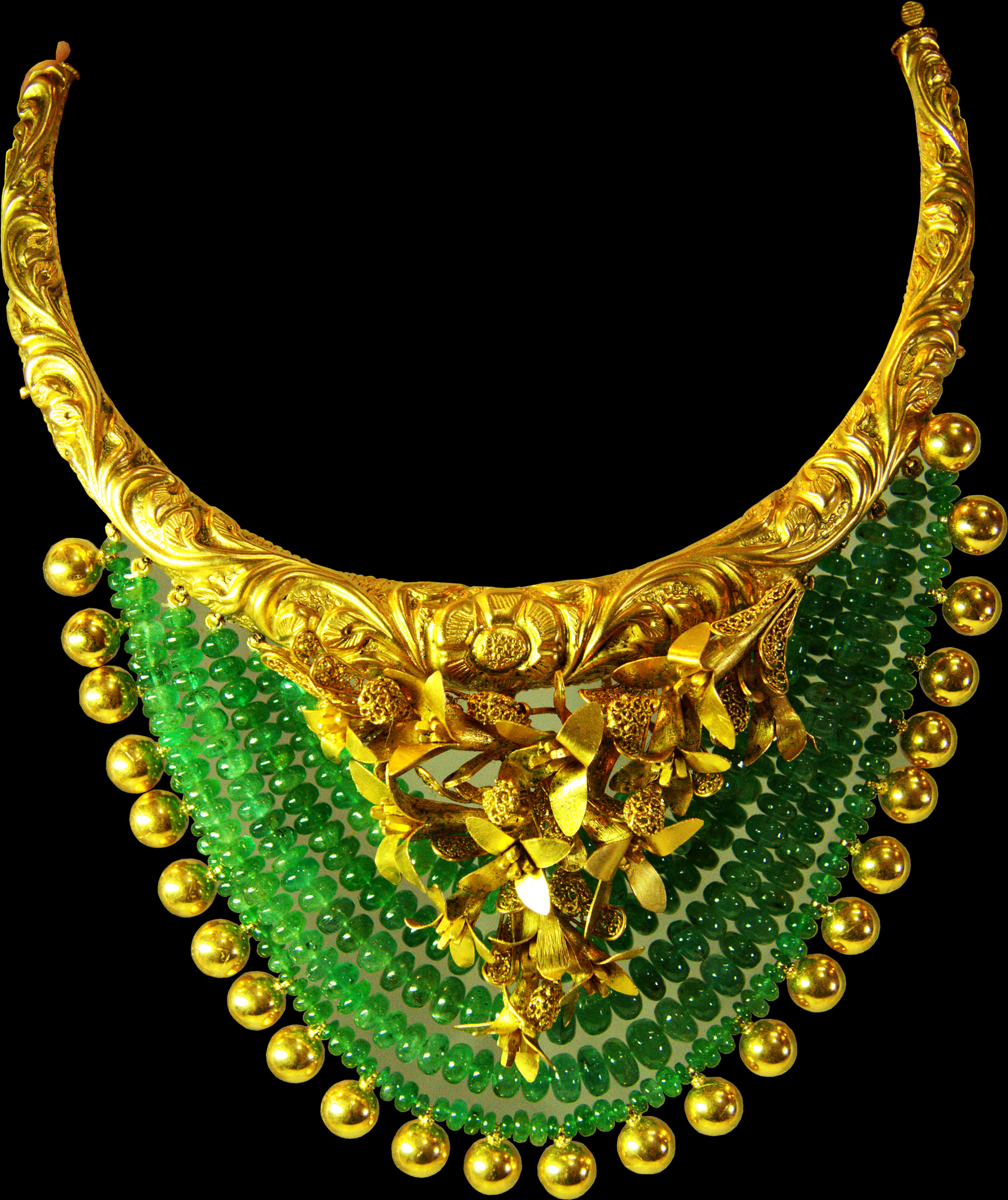 A Gold Necklace With Green Beads